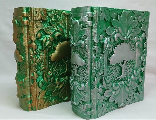 Decorative book with intricate green and gold embossed design on a white background
